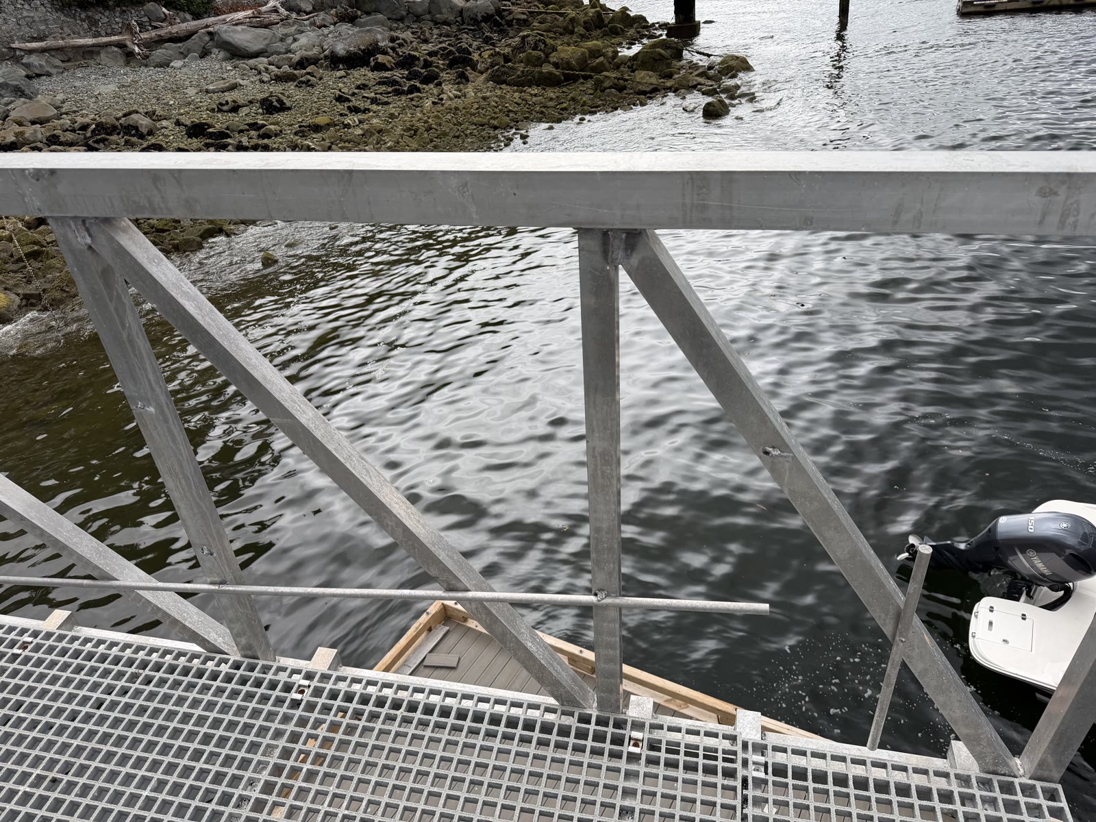 Aluminum gangway railing and grated dock over the shoreline