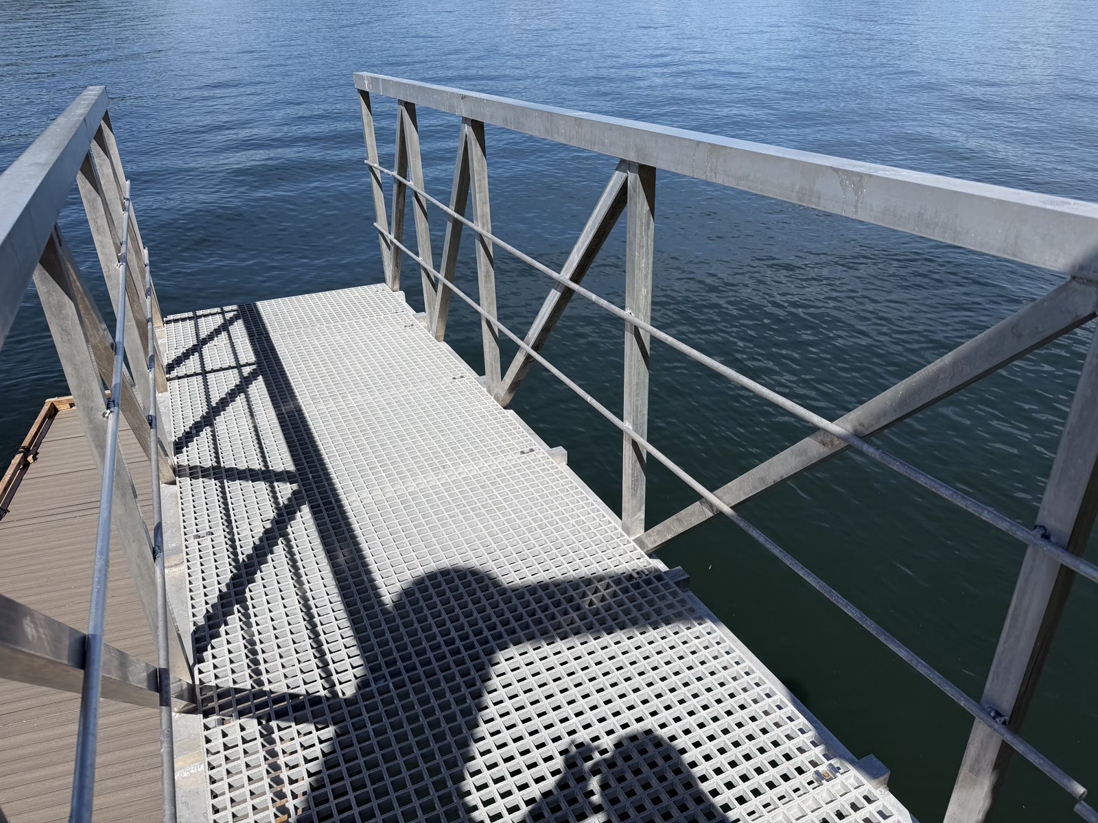 Aluminum gangway with repaired railing over the water