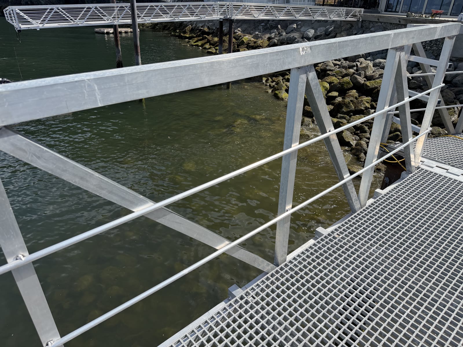 Aluminum gangway railing and dock deck above the water