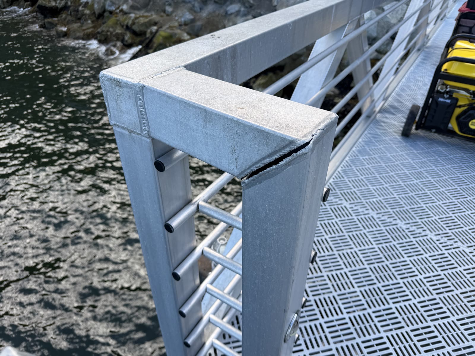 Failed aluminum dock railing corner before repair