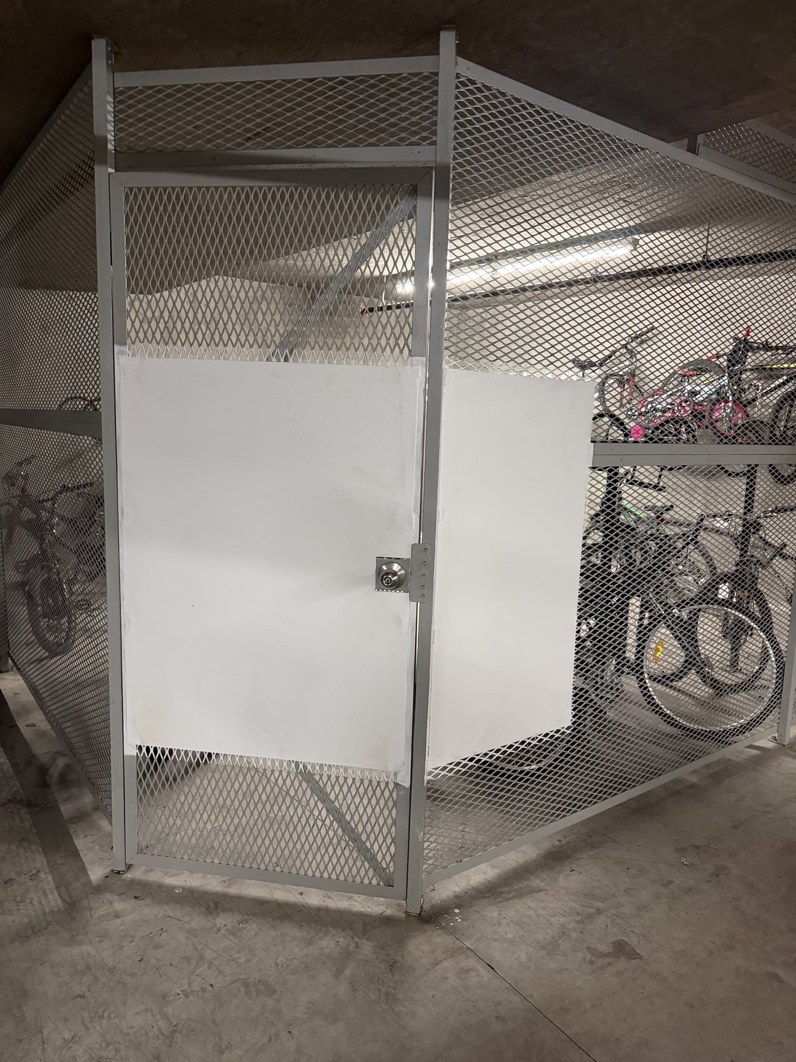 Bike cage mesh reinforced with welded lock plates after break-in