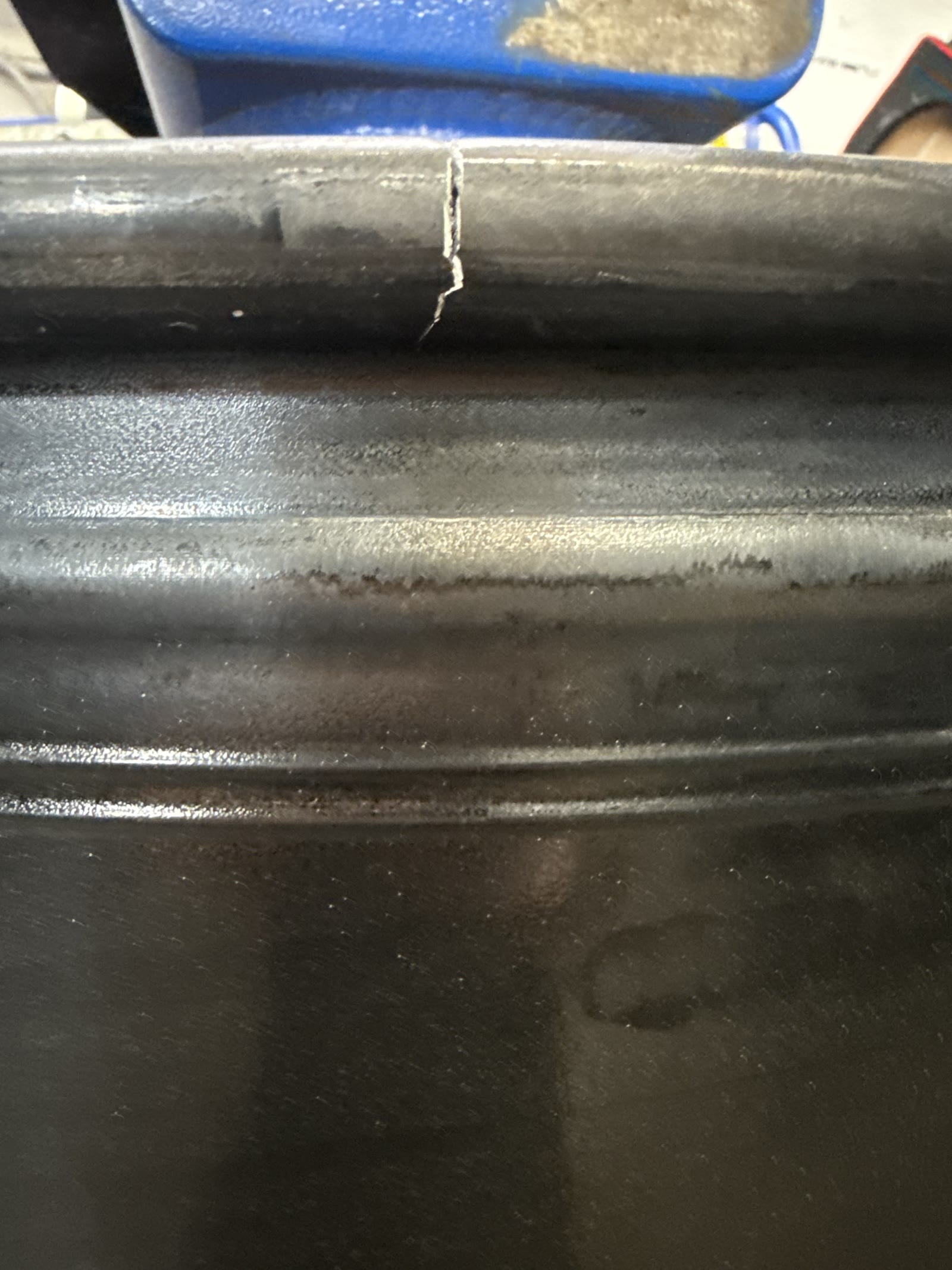 Cracked black wheel rim before repair