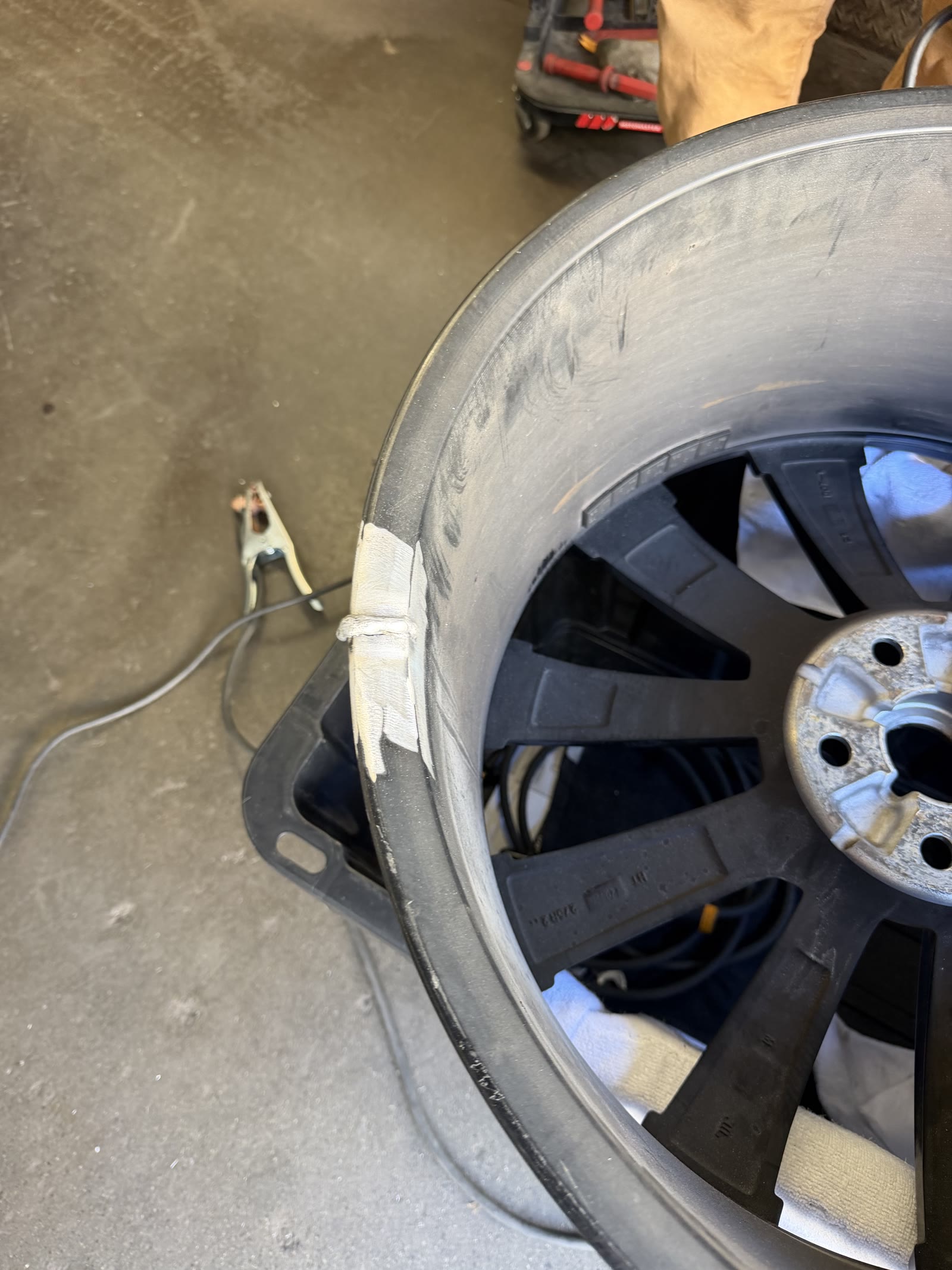 Wheel rim repair in progress during welding prep