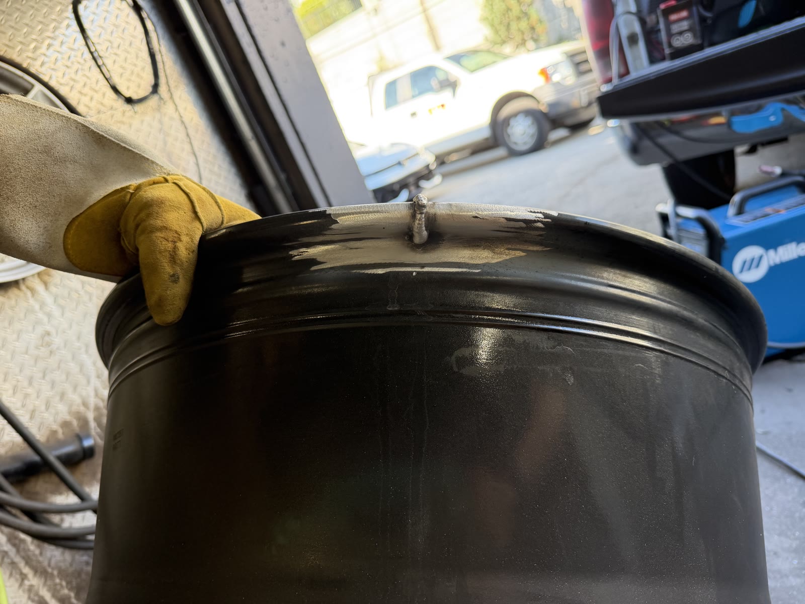Wheel rim mid-repair after welding work